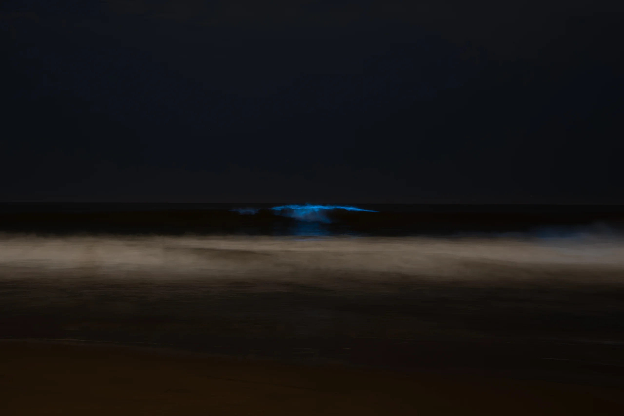 Moonlit water under a dark sky